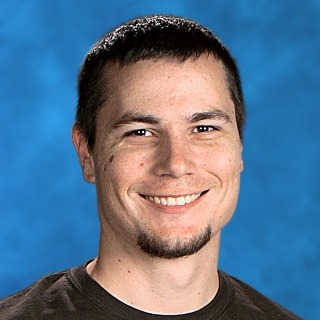 A man with short hair smiling