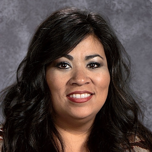A smiling woman with black hair