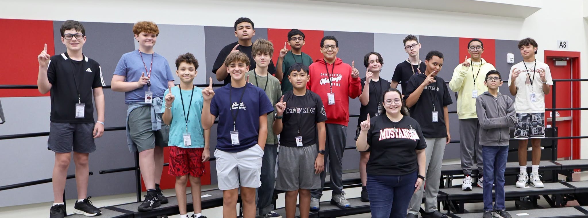 A classroom of choir students posing for a group photo.