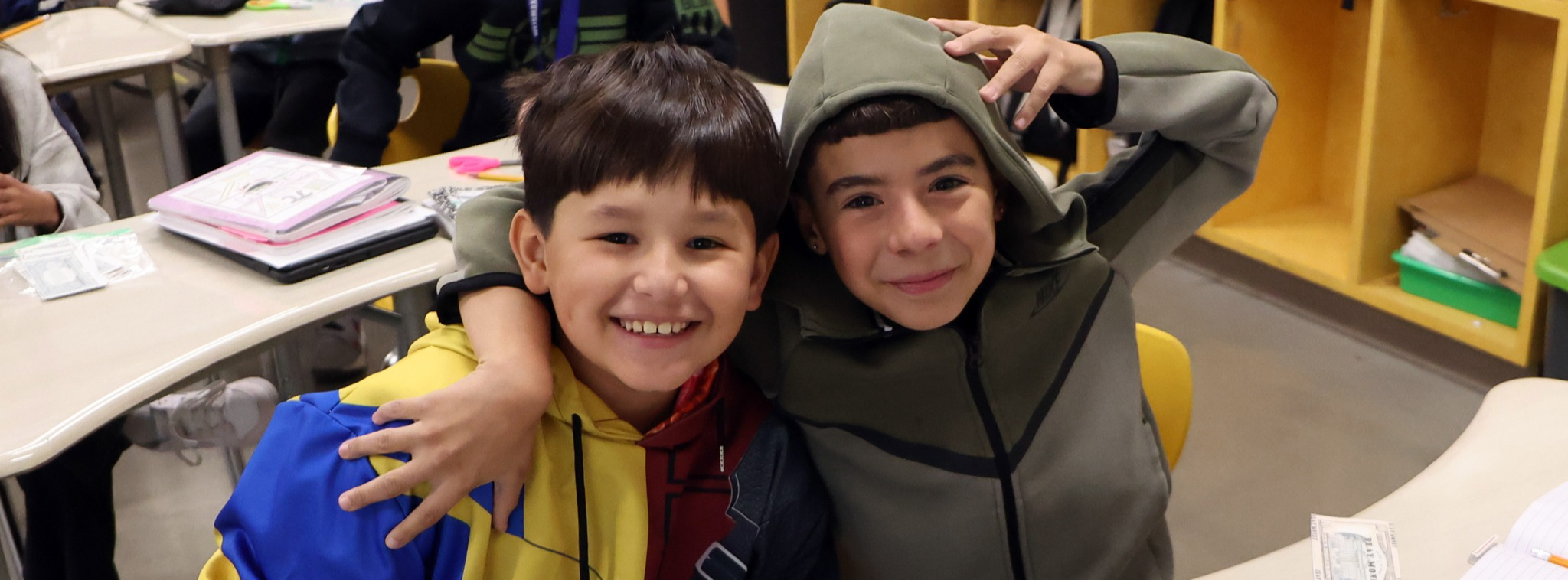 Two students smiling at the camera