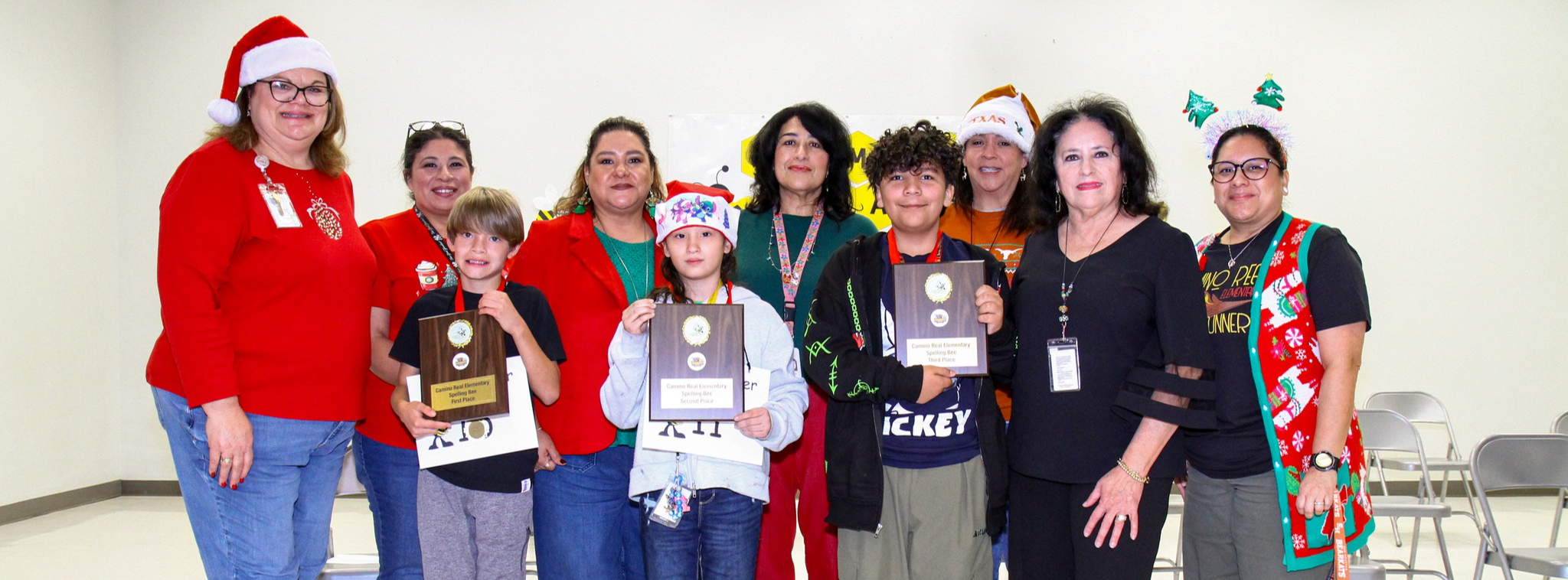Spelling bee judges with first, second and third place spelling bee winners