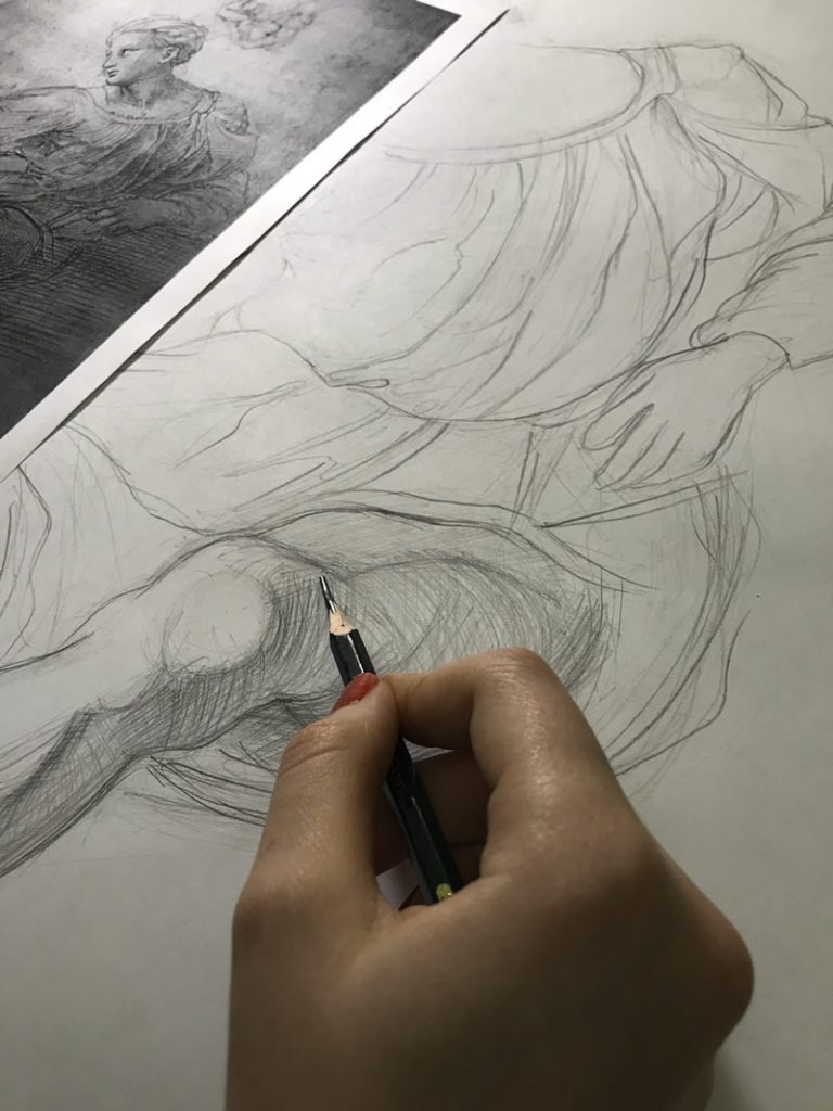 a hand making a drawing