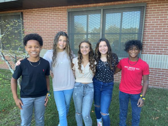 Friends posing together for a group picture.