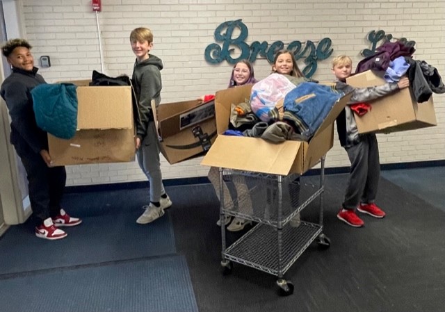 Kids holding boxes with stuff