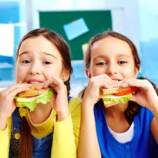 Two students eating sandwiches