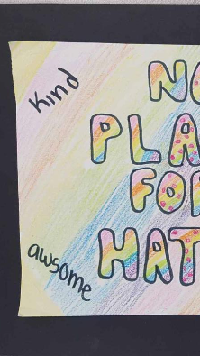 A colorful poster with the text 'NO PLACE FOR HATE' prominently displayed, surrounded by the words 'kind' and 'awesome' in a playful font.