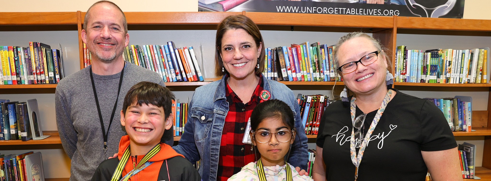 Admin with first and second place winners for the spelling bee