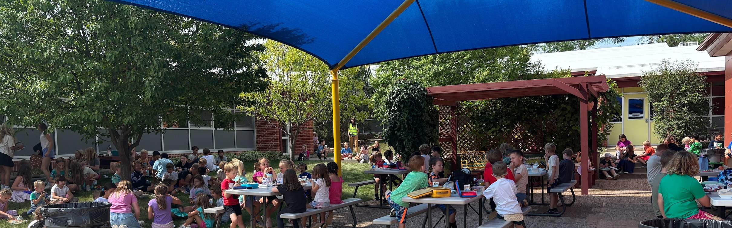 students eating lunch in the courtyard outside