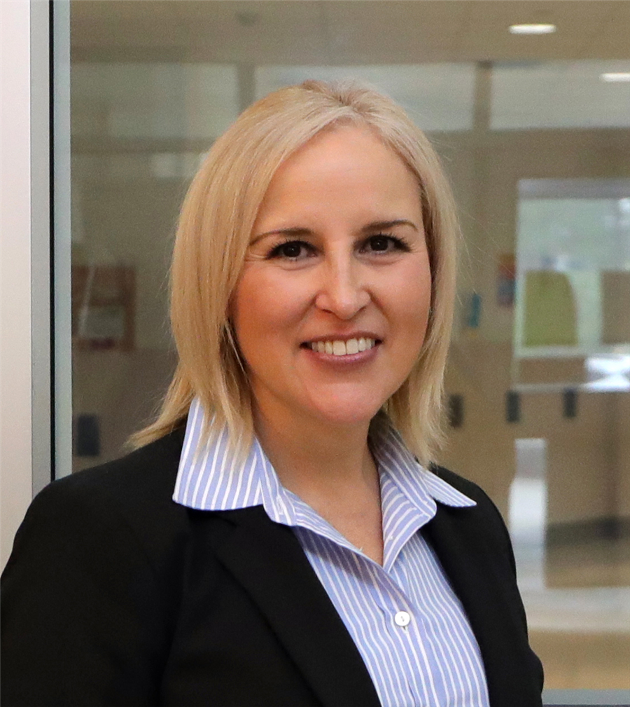 A woman with short blonde hair smiling