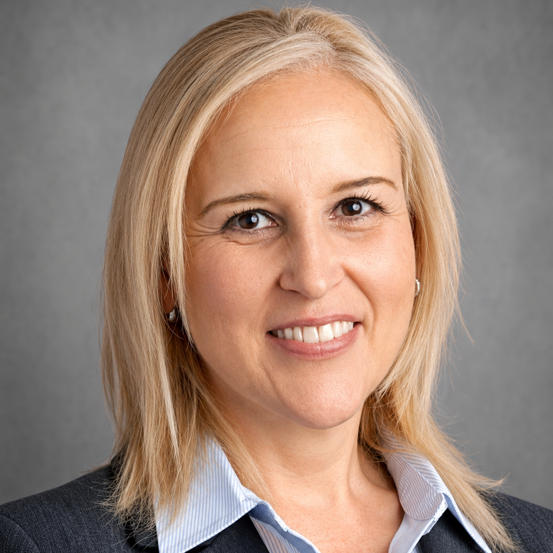 A woman with short blonde hair smiling