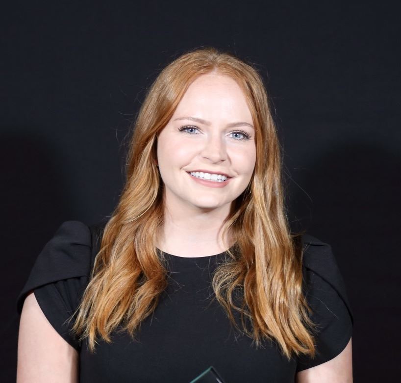 A woman with red hair smiling