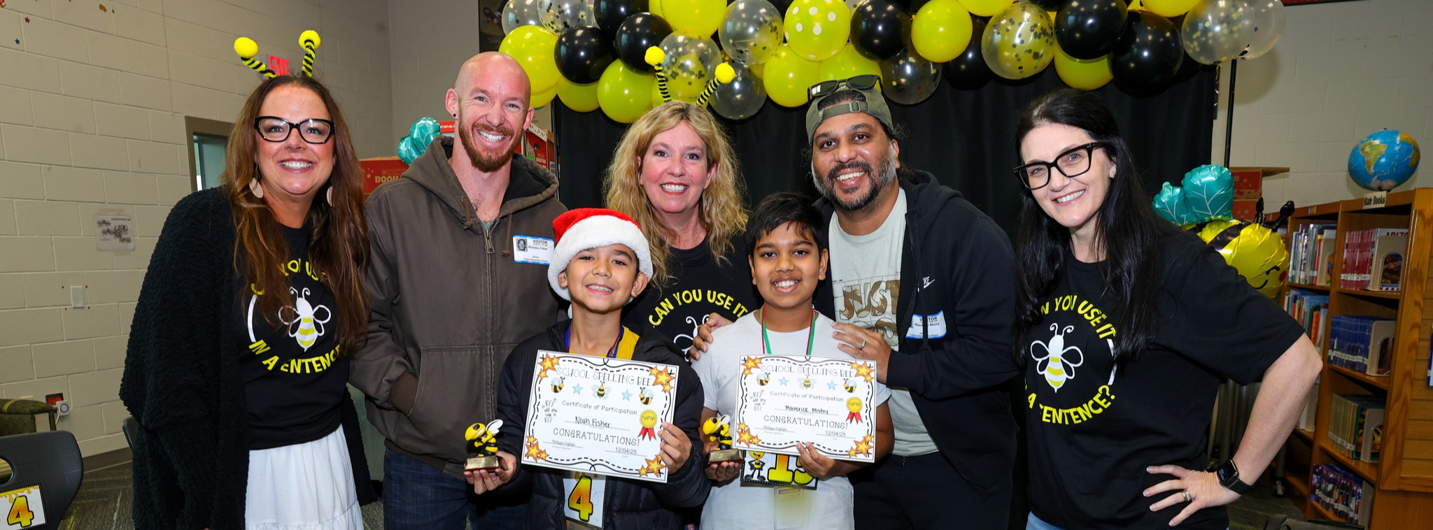 Spelling bee winners surrounded by board members and their dads.