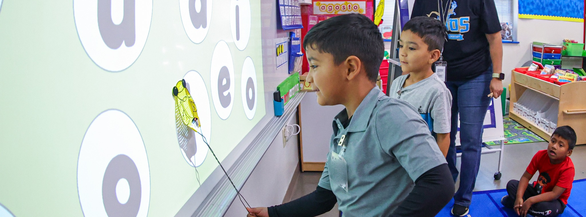 A student engaging with the whiteboard in class.