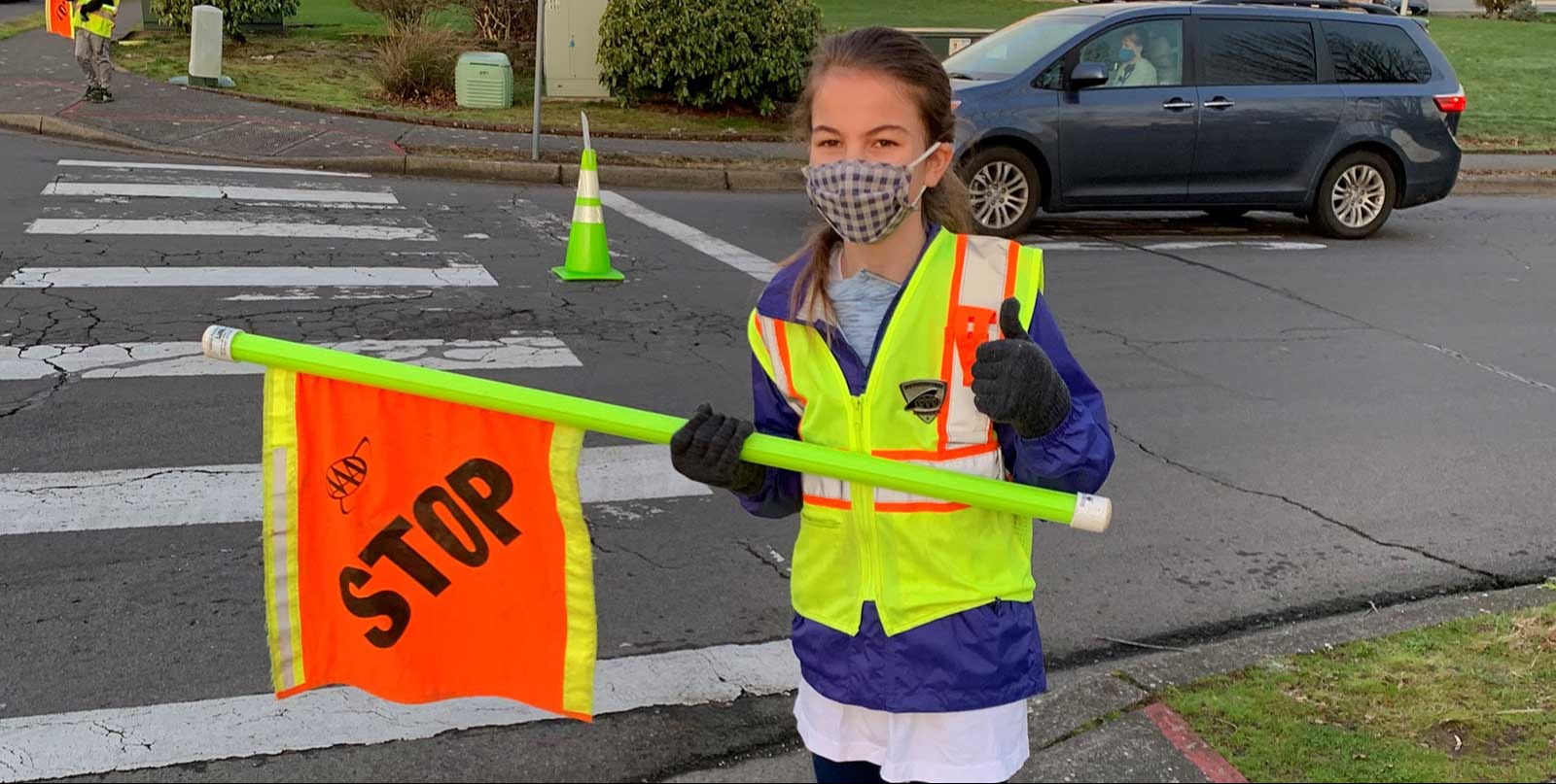 student holding a stop sign