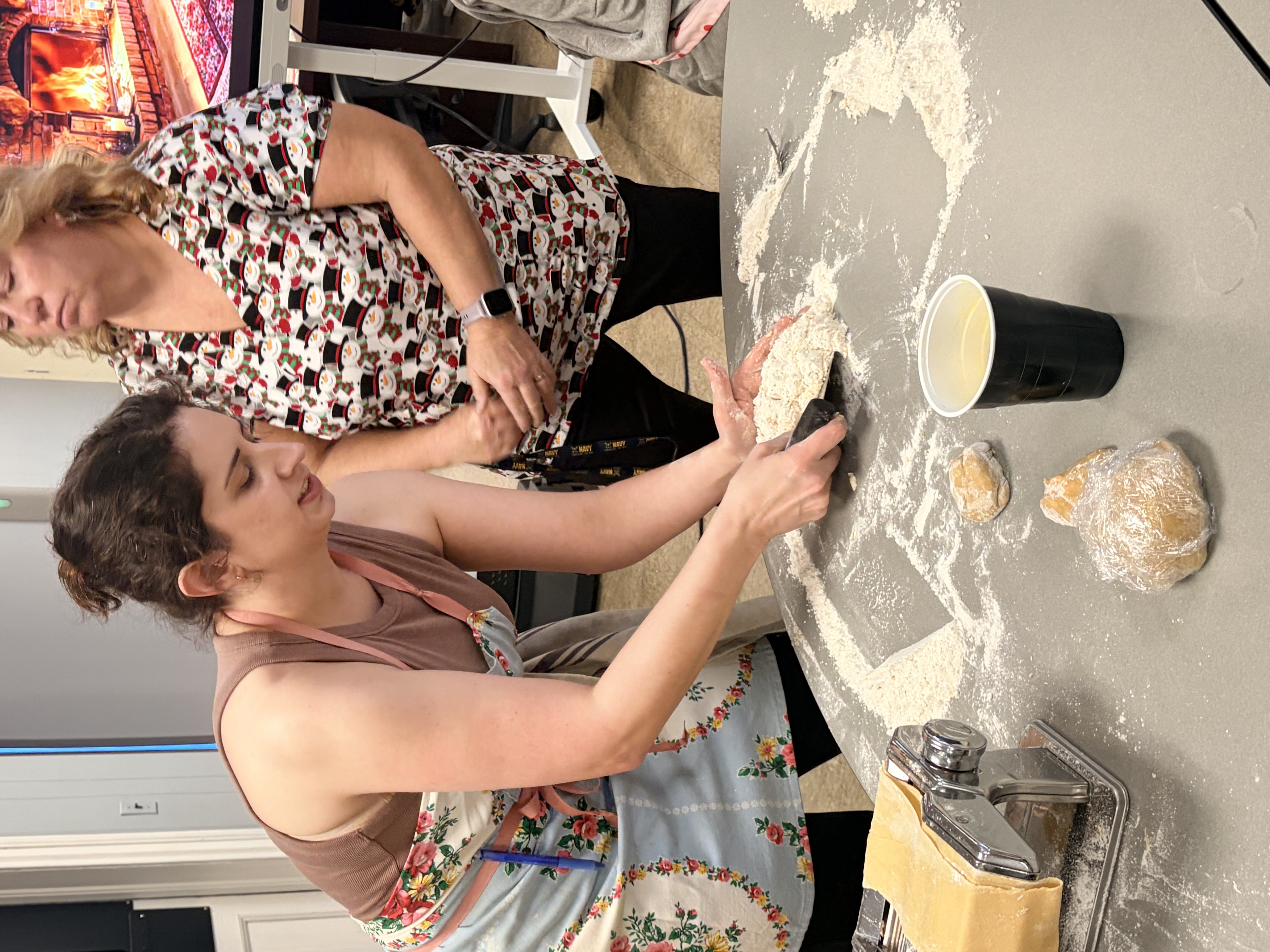 Teacher demonstrating how to make fresh pasta.