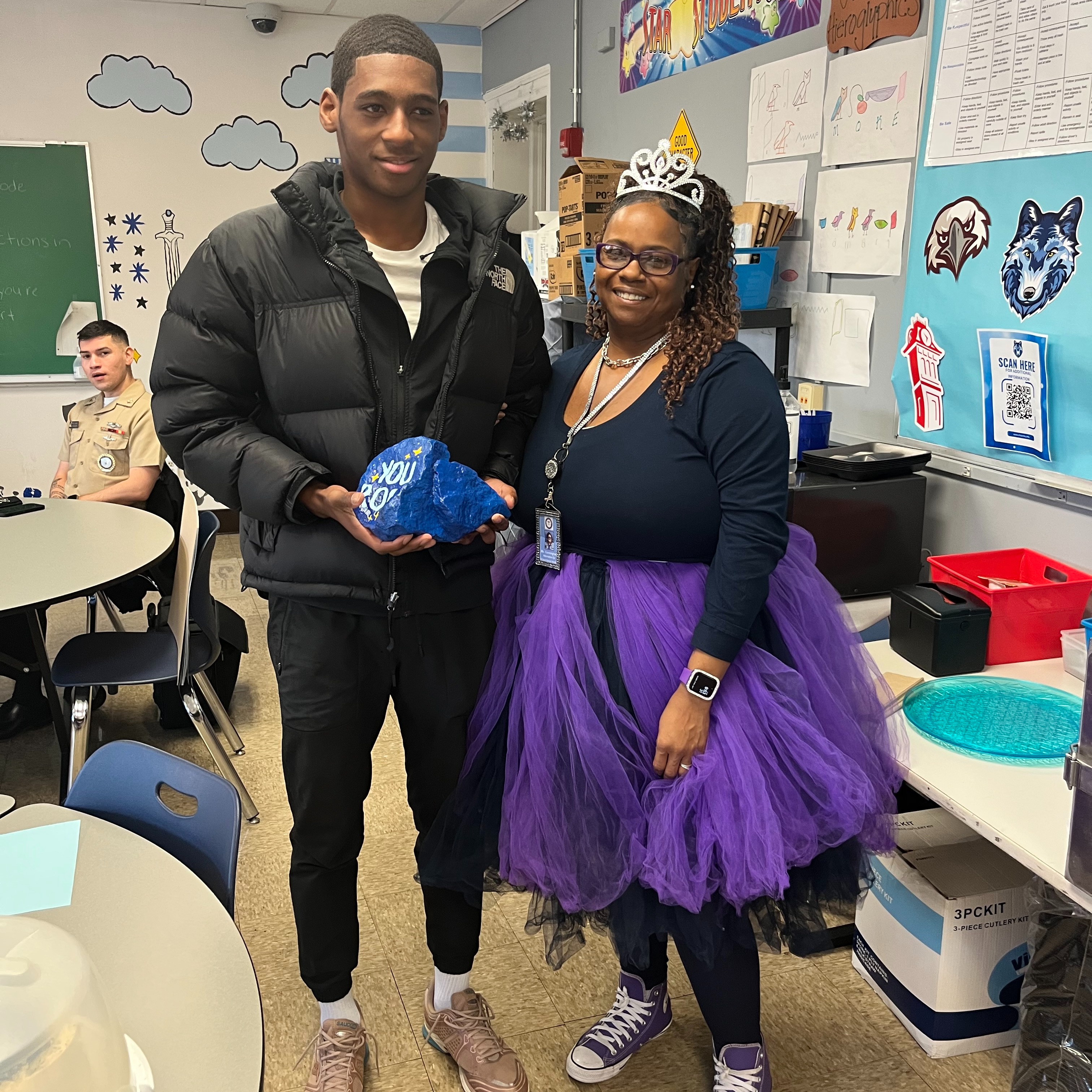 A student and the school social worker smiling for the student and employee of the month photo.