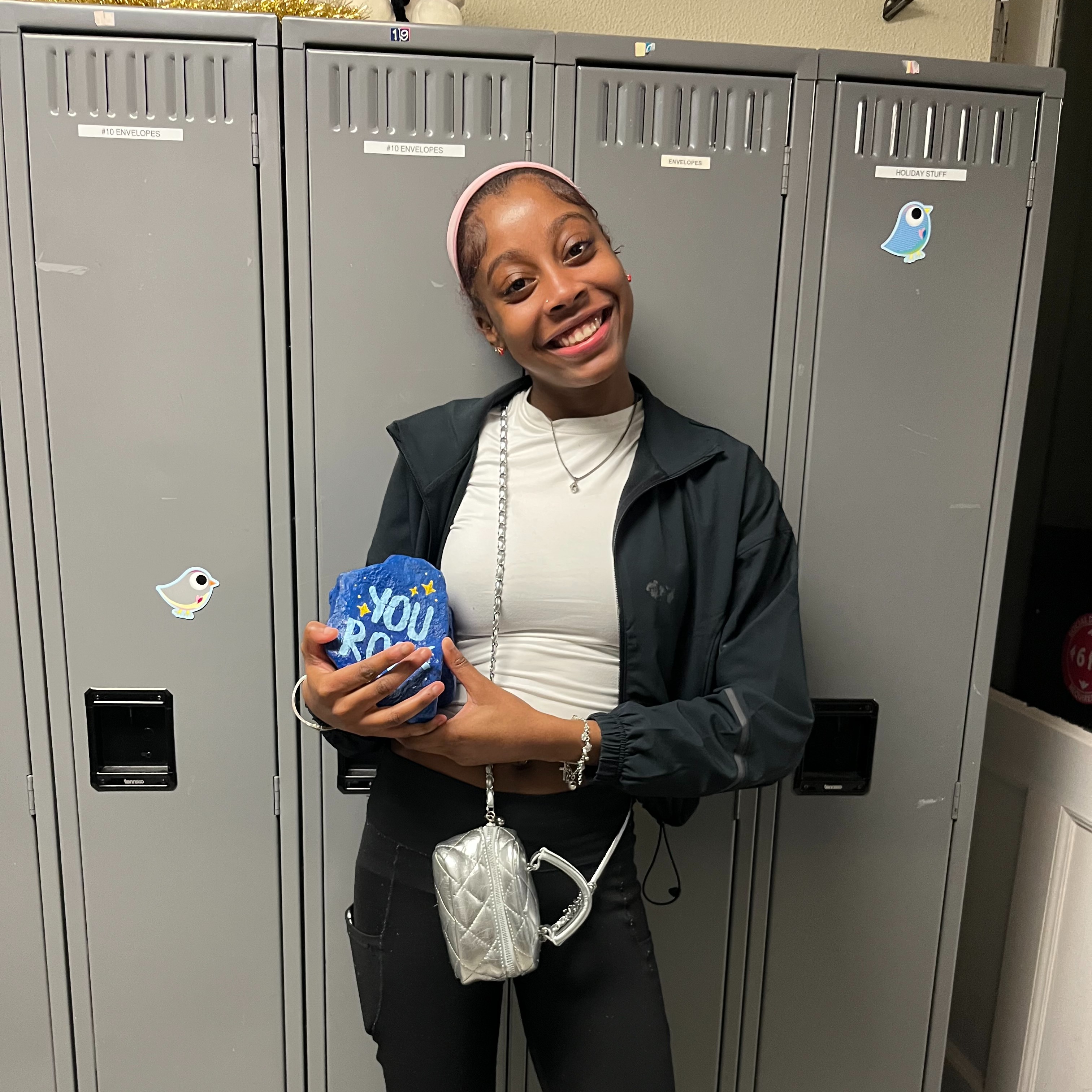 Student of the month smiling with her award.