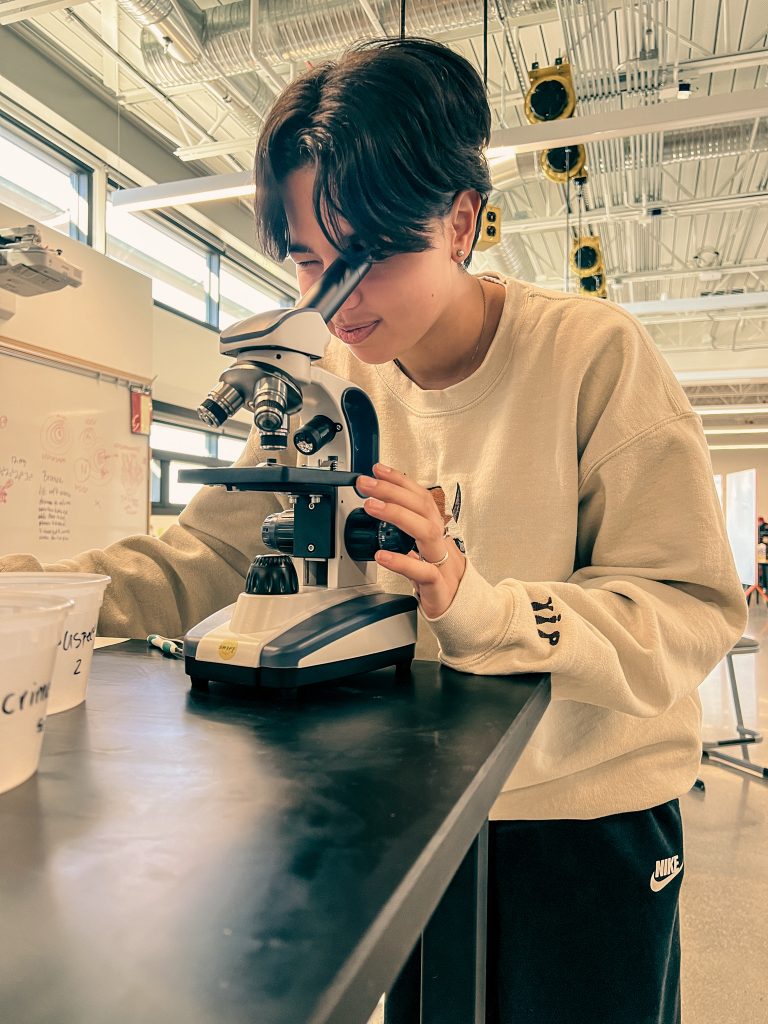 student in a microscope