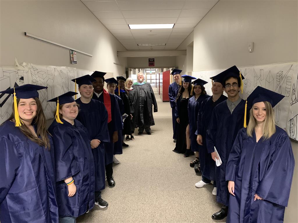 Graduation day for graduates in blue robes.