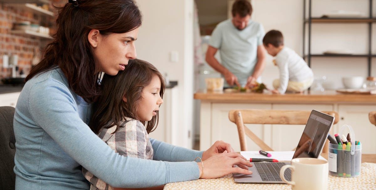 a family cooking and mother with child on laptop