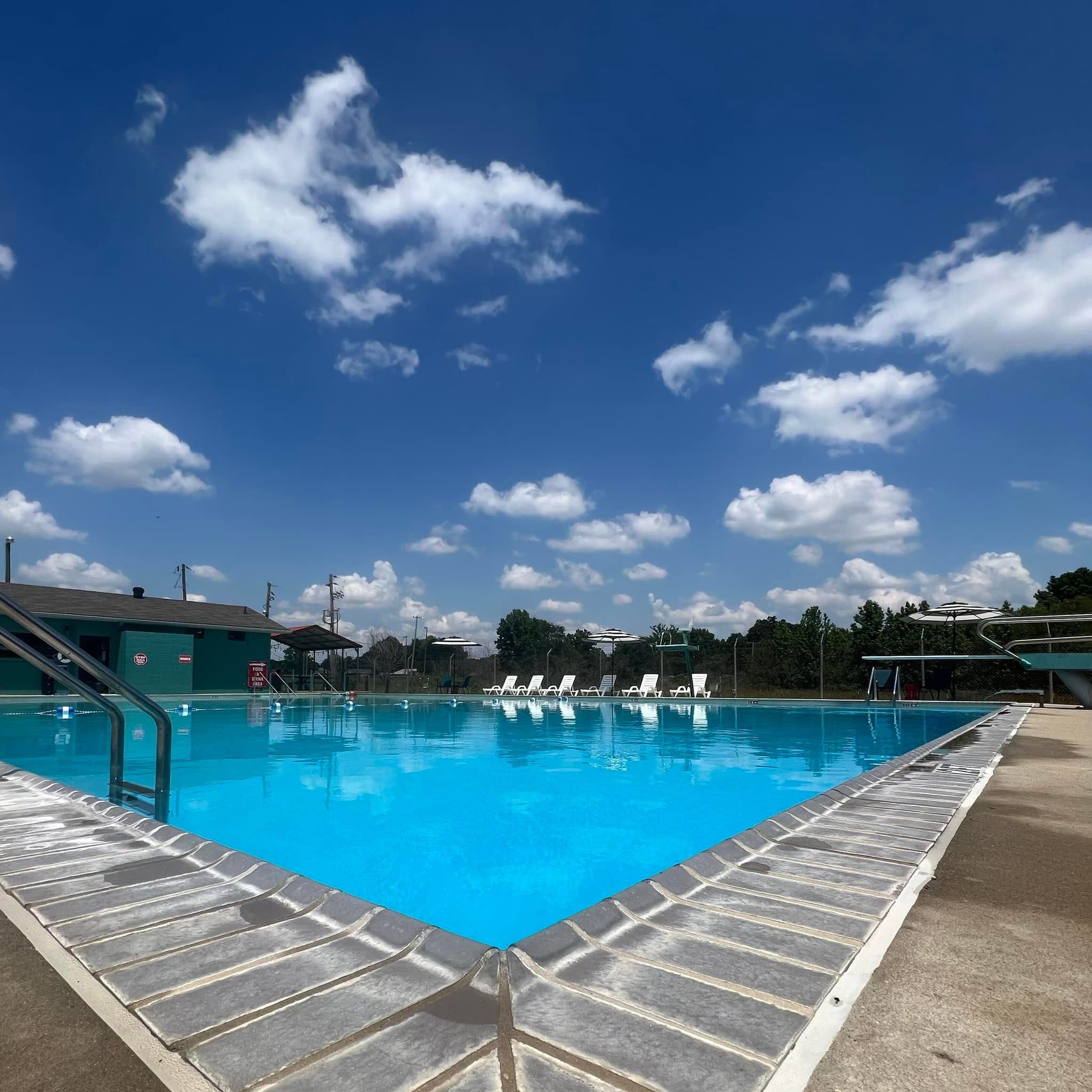Corner of Pool with Blue Sky and White Clouds