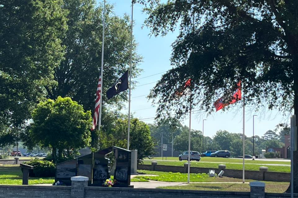 Monument at Veterans Park with Flags at Half Staff
