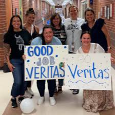 Veritas community leaders cheering in the hallway