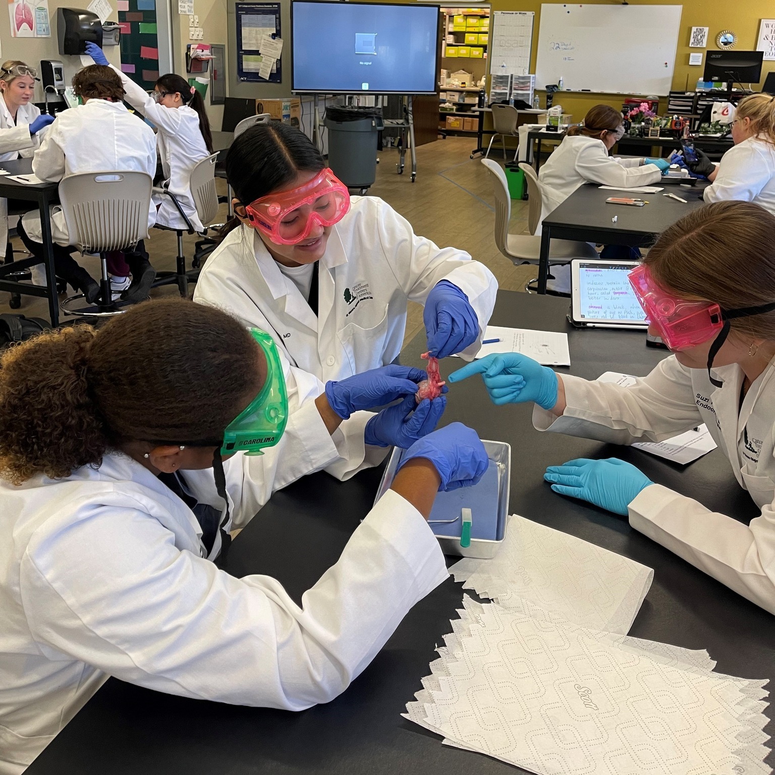 MET Medical Students working on a project at a table