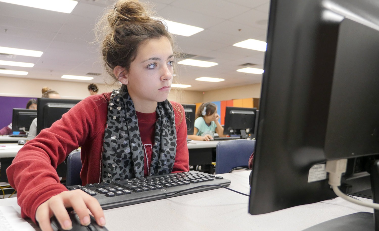 A student working on a computer in a computer lab.