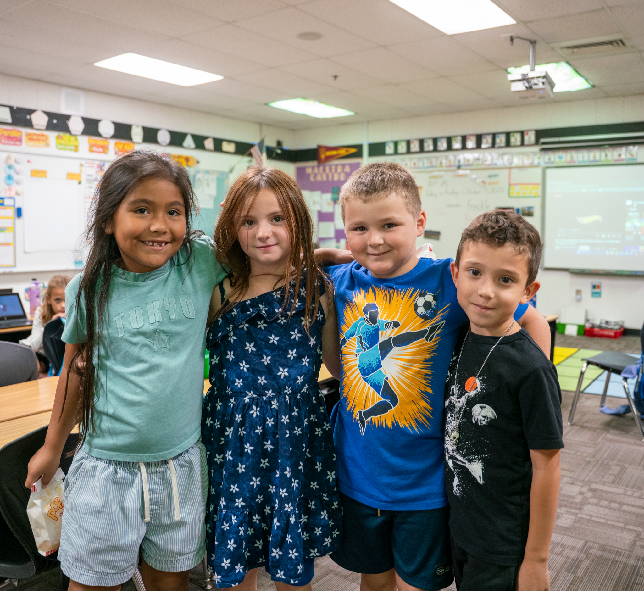 Students posing as a group in a classroom