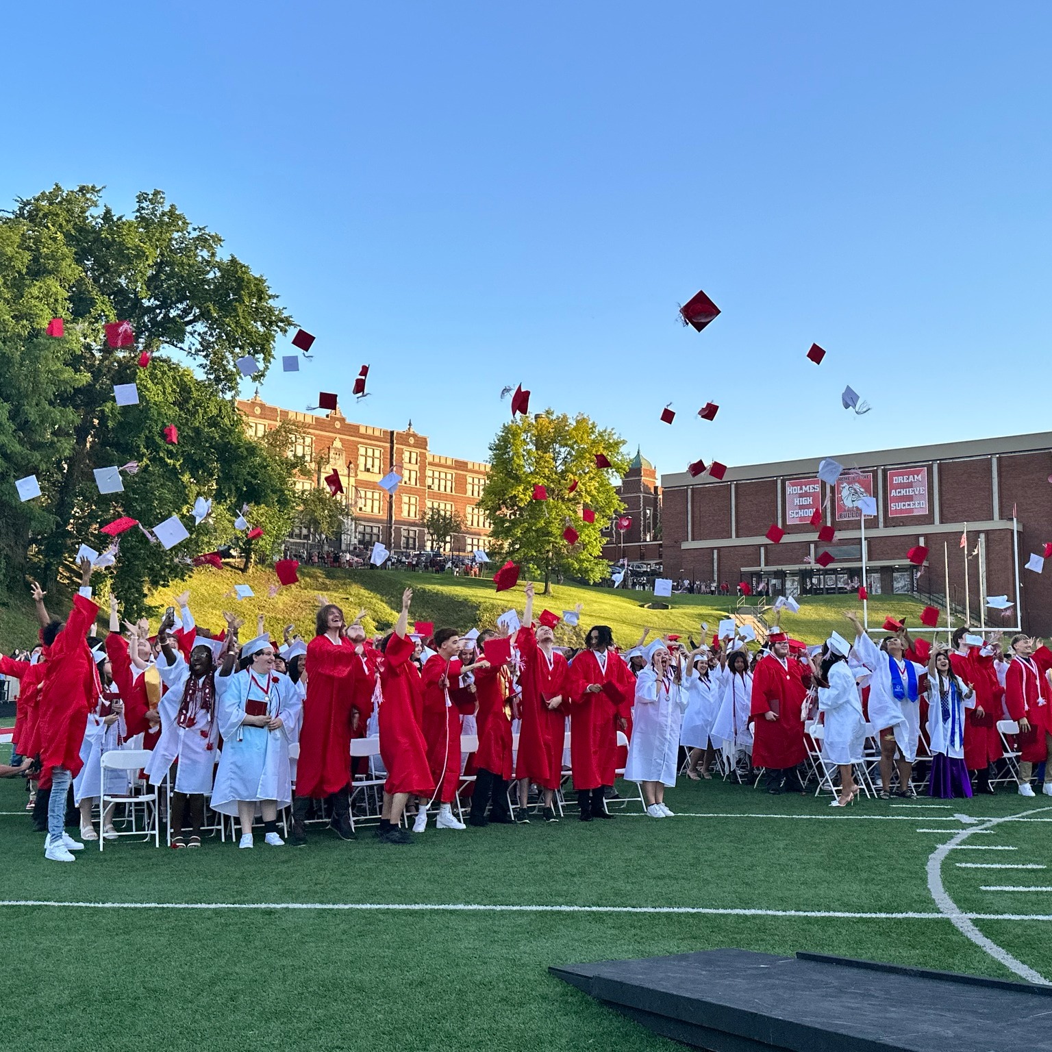 HHS graduation - students tossing caps