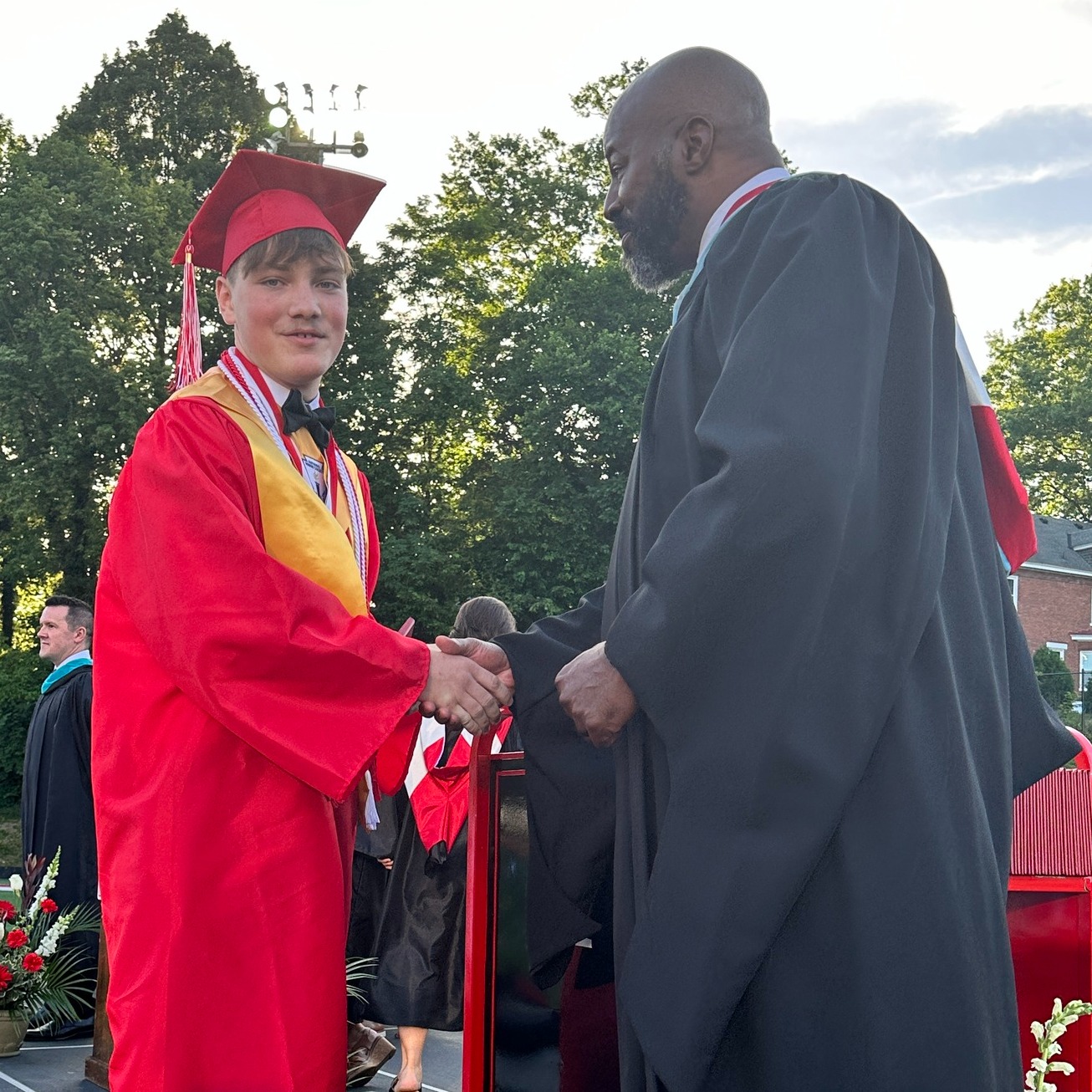 HHS graduate shakes hands with Mr. Garrison