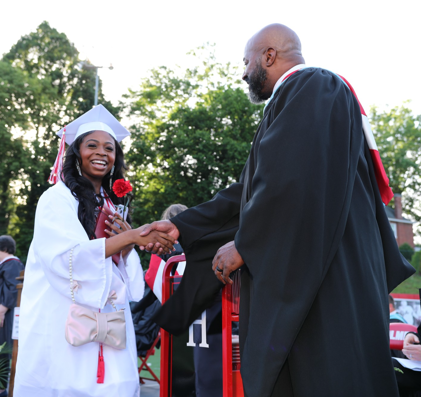 female graduate shakes hands with Superintendent Garrison