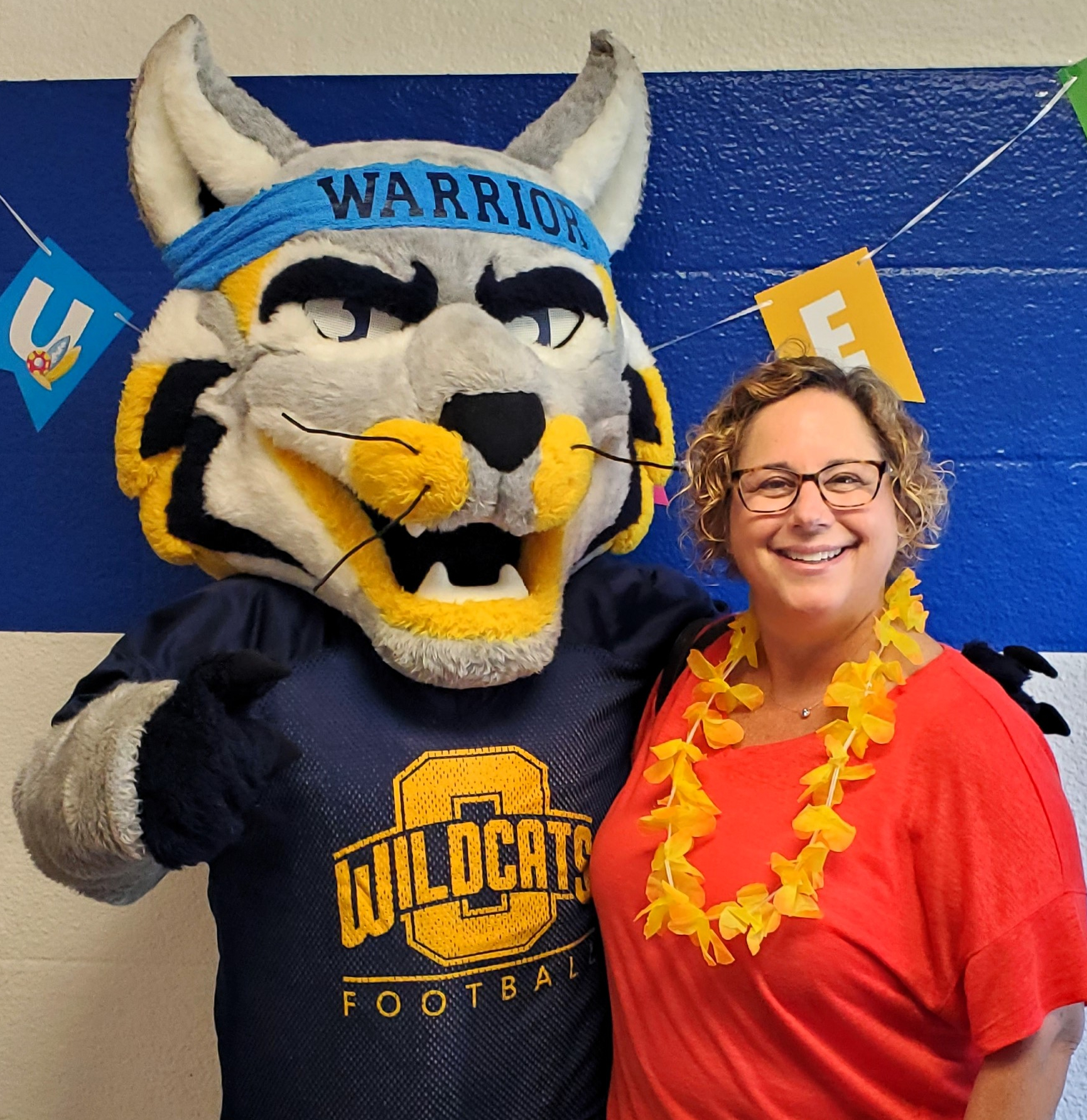 Oxford wildcat mascot standing with superintendent