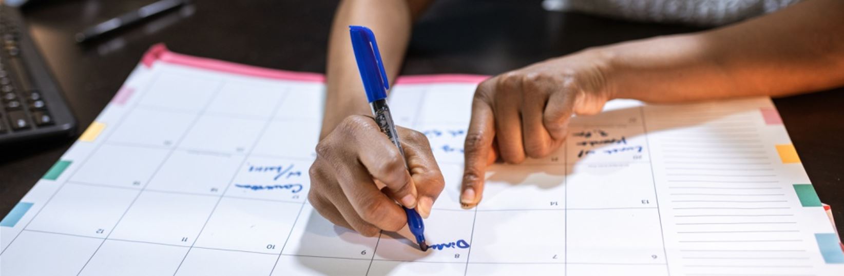 woman writing in calendar