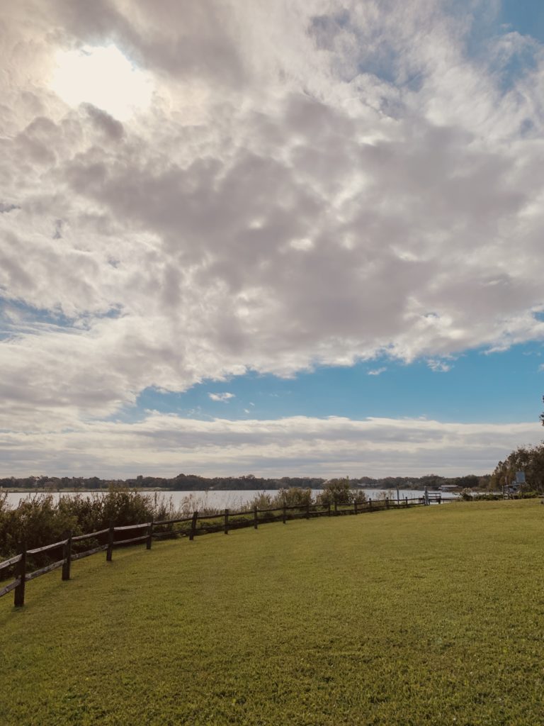 Grass field with lake in the background