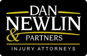 A logo featuring the name 'Dan Newlin & Partners' in bold white and yellow text on a black background, with the phrase 'Injury Attorneys' below.