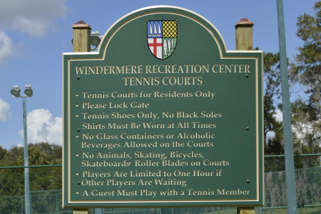 A sign at Windermere Recreation Center outlining the rules for using the tennis courts, including restrictions on footwear and guest policies.
