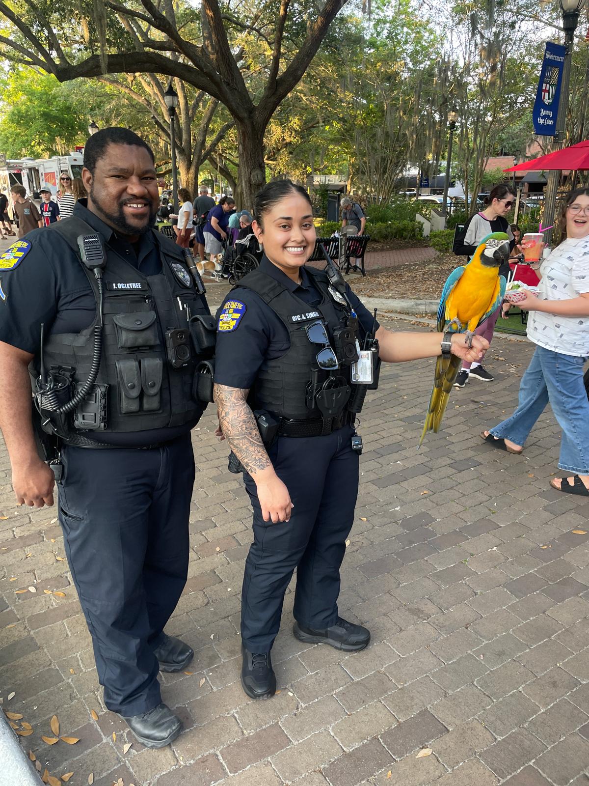 Officer Ogletree and Singh with Blue the bird