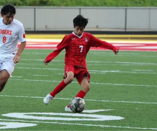 boy playing soccer