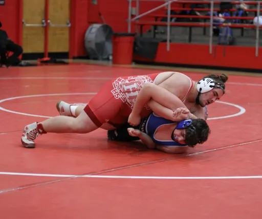 2 boy wrestling in the gym 