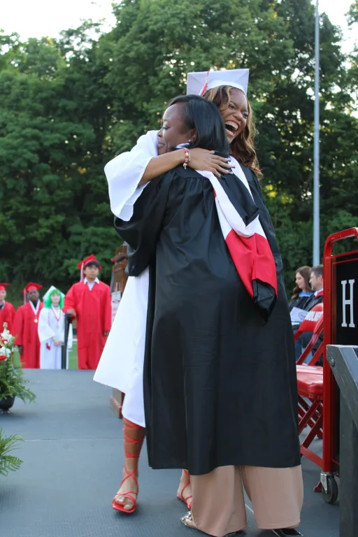 teacher and student hugging 