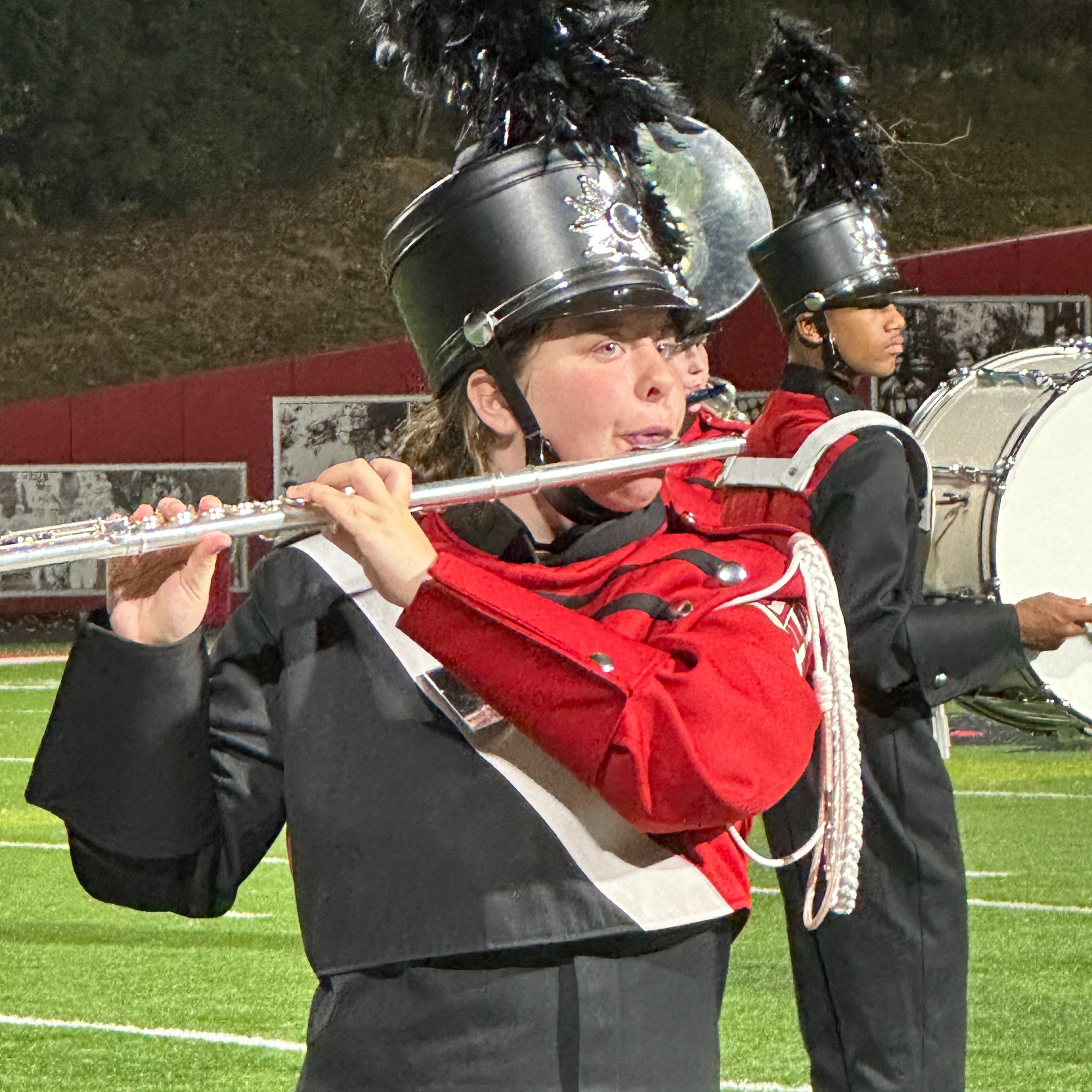female marching band student playing the flute