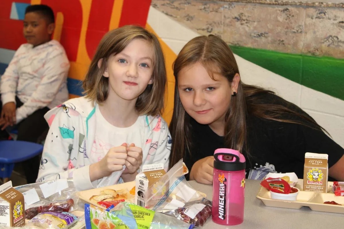 students smiling at cafeteria