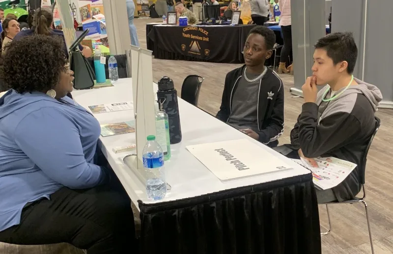 3 students Talking on a table