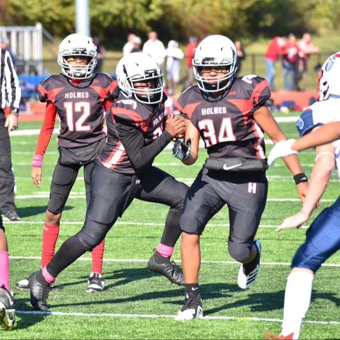 holmes football player runs a play