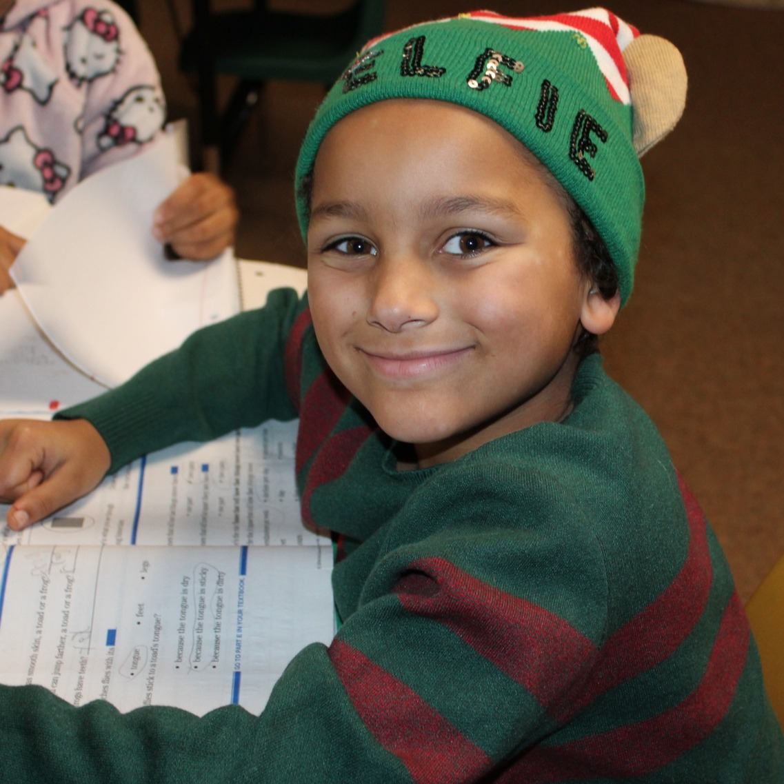 a boy smiles at the camera