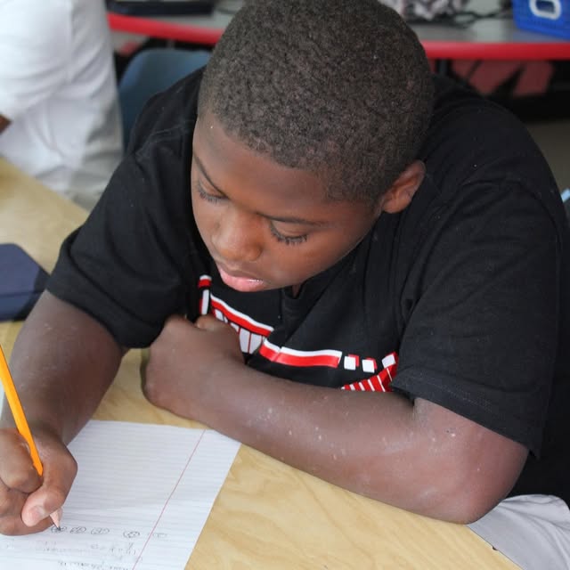 young male student doing his schoolwork