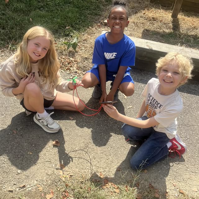 three young students playing together