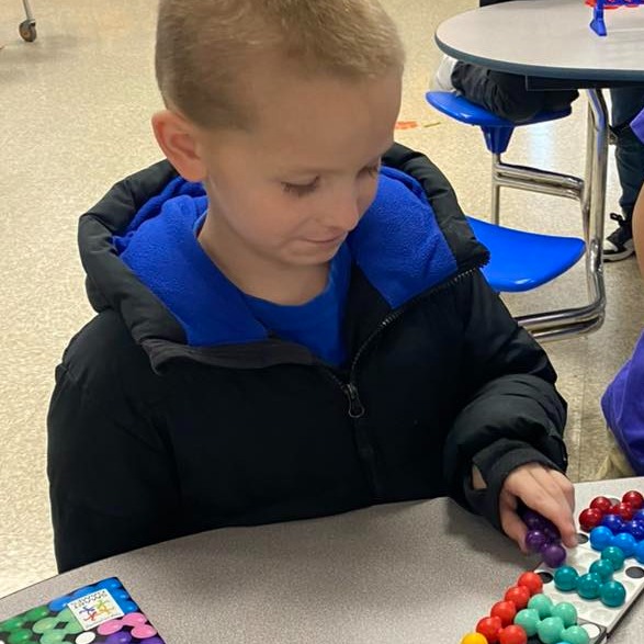 boy playing a game of marbles